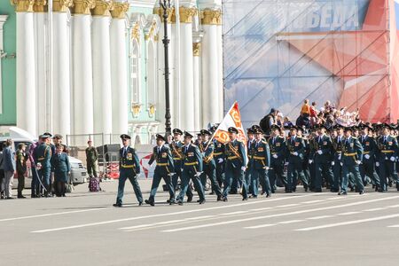Military unit with a flag on the march. Military Victory Parade at the Palace Square in St. Petersburg.のeditorial素材