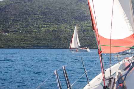 Yachts makes a turn near buoy. Sea race on yachts in the Bay of Kotor Adriatic Sea.のeditorial素材