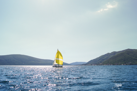 The picturesque landscape with a boat. Sea race on yachts in the Bay of Kotor Adriatic Sea.のeditorial素材