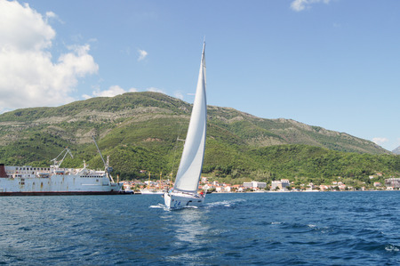 The boat runs from the shore. Sea race on yachts in the Bay of Kotor Adriatic Sea.のeditorial素材
