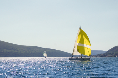 Two yachts on calm water. Sea race on yachts in the Bay of Kotor Adriatic Sea.のeditorial素材