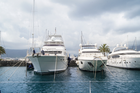 White yacht at the dock. The town of Tivat and the coast of the Bay of Kotor in Montenegro.の写真素材