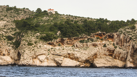 Little House on the rocky shore. The town of Tivat and the coast of the Bay of Kotor in Montenegro.のeditorial素材
