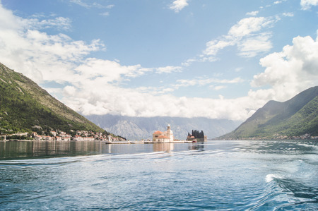 The island in the bay between the mountains. The town of Tivat and the coast of the Bay of Kotor in Montenegro.の写真素材