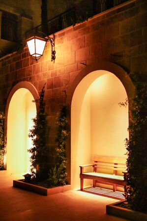 Arches illuminated by the warm light. Elements of architecture backlit in dark time.の写真素材