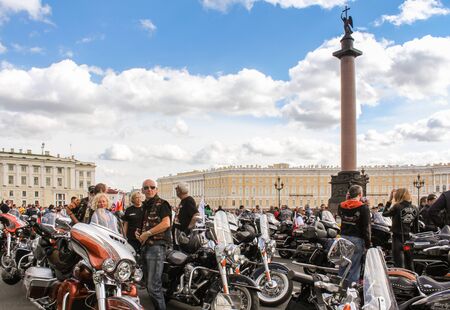 People and motorcycles on the Palace Square. The annual parade of Harley Davidson in the squares and streets of St. Petersburg.のeditorial素材