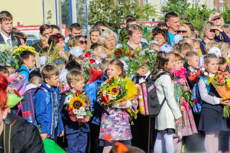 Children with bouquets of flowers. School holiday on the first day of autumn, the Day of Knowledge.のeditorial素材