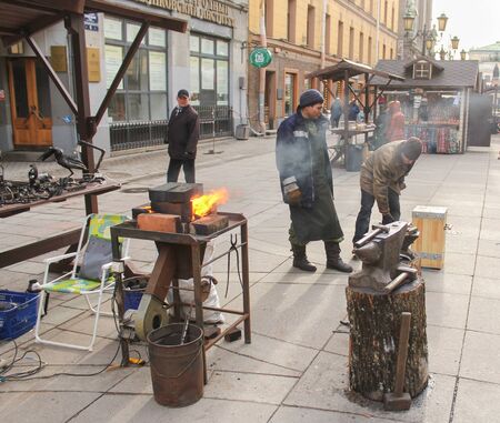 Tools for forging and blacksmiths. People in the city at the traditional national holiday of Maslenitsa.のeditorial素材