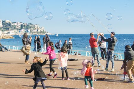Children catch soap bubbles. People and tourists having a rest on the Cote d'Azur.のeditorial素材