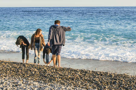 A group of young people by the sea. People and tourists having a rest on the Cote d'Azur.のeditorial素材