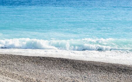 The surf of the surf rushes to the shore.の写真素材