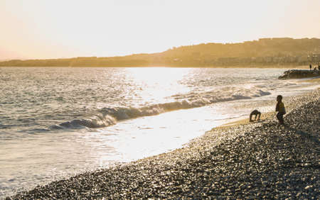 Sunset on the shore. People and tourists having a rest on the Cote d'Azur.の写真素材