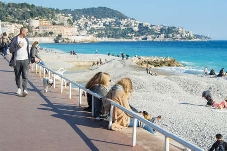 Tourists on the waterfront. People and tourists having a rest on the Cote d'Azur.のeditorial素材