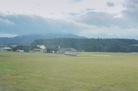 Houses in the fog. View from the window of a train on a trip across Europe.の写真素材