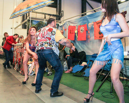 Dancing in public. Erotic dances of the girls at the motor show.のeditorial素材