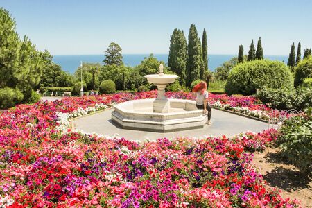 The girl at the bowl of the fountain. Landscape park around the Levadsky Palace.のeditorial素材