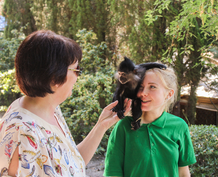 People with a monkey. Zoo and animals on the territory of the hotel Yalta Intourist.のeditorial素材