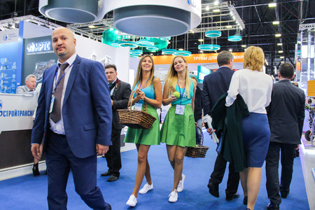 Girls with apples between people. Participants and visitors of the annual Petersburg Gas Forum.のeditorial素材