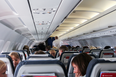 Passengers and attendants in the cabin of the airliner.