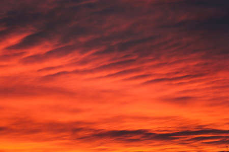 Picturesque clouds in the sky backlit by the sun.