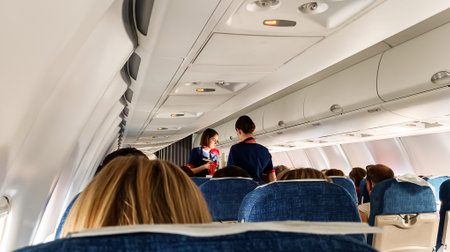 People in the cabin of an airplane during a flight.