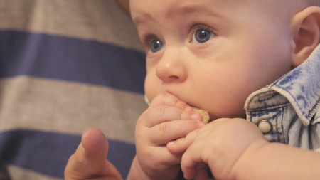 A cute kid himself eats a delicious meal, close-up. hdの写真素材