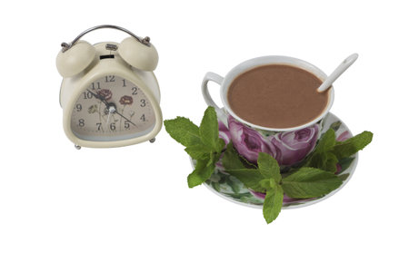 Isolated on white background Color cup of coffee on a saucer with a spoon, decorated with mint...