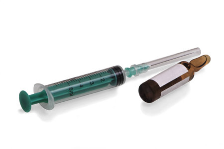 Medical supplies syringe and vial on a white background with shadow.の写真素材