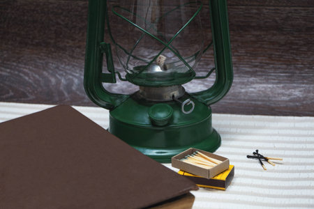 Still life with a kerosene lamp on the background of wood.の写真素材