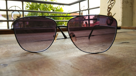 side closeup crop stylish eye goggles on wooden background.