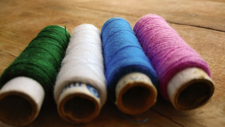 Multicolor sewing threads on white background