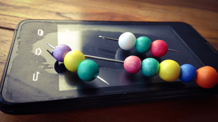 colorful bubbles on mobile phone with wood background