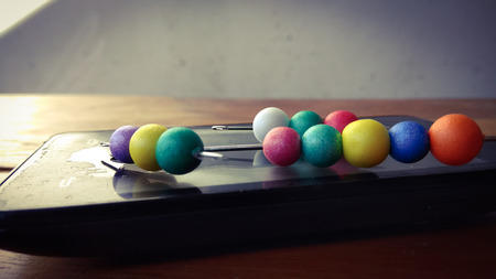 colorful bubbles on mobile phone with wood backgroundの写真素材