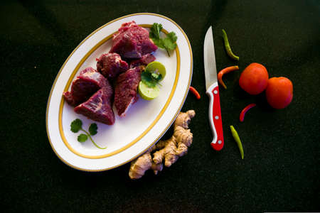 Fresh Beef steaks decorated with vegetables and herbs on a white plate,Selective focus.