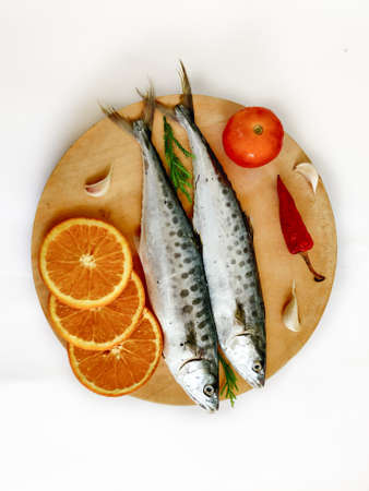 Fresh Seer Fish,King Fish decorated with herbs and vegetables on a wooden pad,Selective Focus.の写真素材