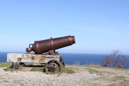 old cannon on top of a hill, facing the oceanの写真素材