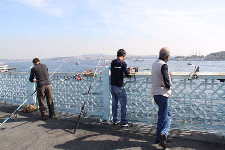 Fishermen casting their lines from a bridge