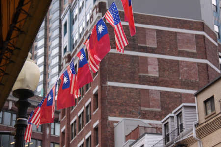 red blue white korean and american flags alternating hung on a stringの写真素材