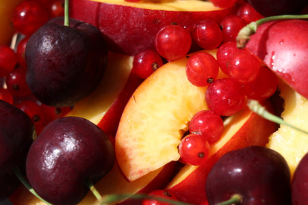 Closeup of a plate of fresh fruits with red currant, cherries and peachの写真素材