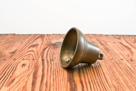 bronze bell on wooden tableの写真素材