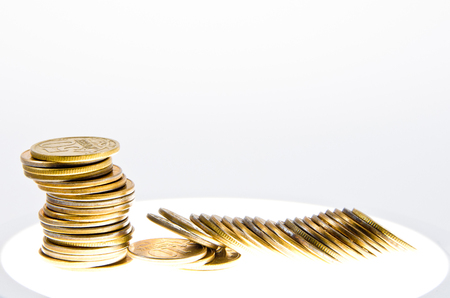 a stack of coins on a luminous tableの写真素材