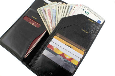Essential kit for the traveller: purse, credit cards, passports and money from different countries