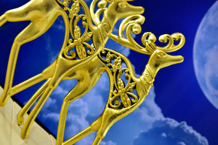 the gold figures of stags in the background of the moonの写真素材
