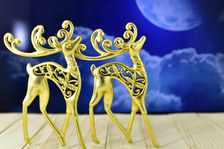 the gold figures of deer in the background of the moonの写真素材