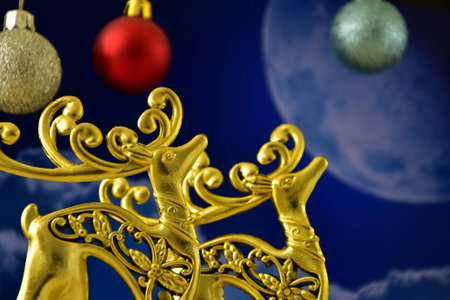 the gold figures of deer in the background of the moonの写真素材