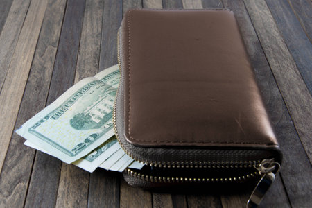 Dollar banknotes ,a lot of dollars form wallet, on wooden background.