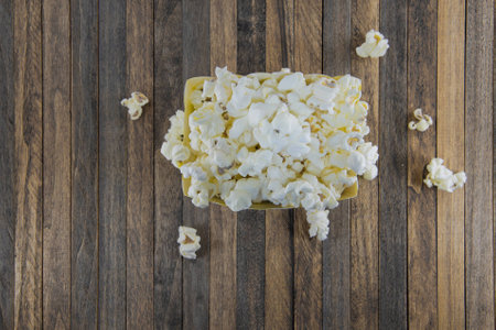 A box of popcorn on a wooden backgroundの写真素材