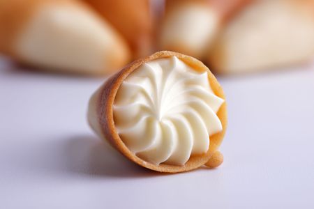 Sugar tubule with a cream against others の写真素材