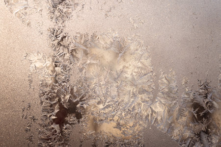 Cold winter morning ice flowers on glass, background with copy spaceの写真素材