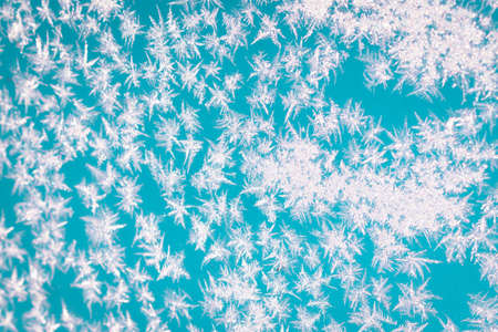 Cold winter morning ice flowers on glass, background with copy spaceの写真素材